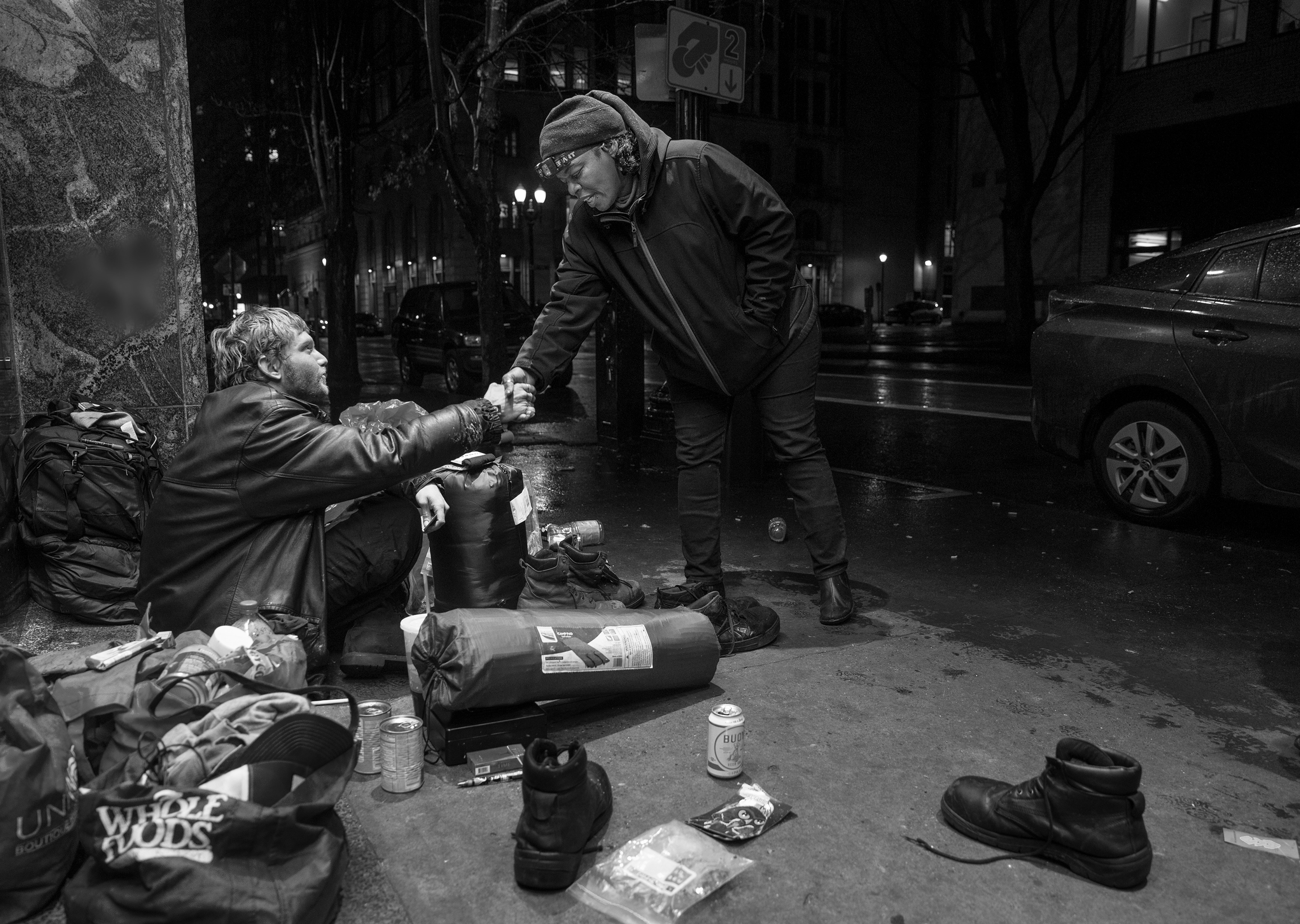 Person shaking hands with a person experiencing homelessness